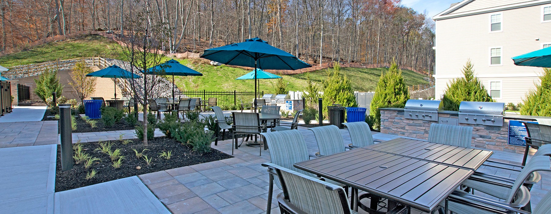 Woodgrove at Sterlington outdoor patio with tables and umbrella coverings